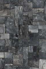 A close-up view of a textured slate stone wall with varying shades of gray.