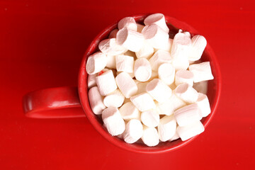 cup with marshmallow on tap background