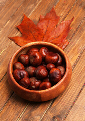 bowl of chestnuts on wooden background