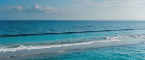 Obraz premium Tranquil Seascape of Clear Blue Waters and Gentle Waves with Expansive Sky Ideal for Text Overlay or Promotional Use