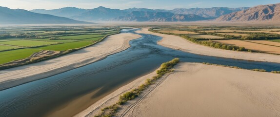 Aerial Landscape of Sandy River and Lush Fields with Mountain Range in Background and Expansive Copy Space for Text or Graphics