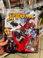 Naklejka premium Kyiv, Ukraine - February 04, 2025: Spider Man theme toy set and comic magazine bundled and displayed in a store.