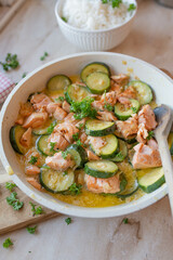 Healthy pan dish with salmon fillet and vegetables in a skillet
