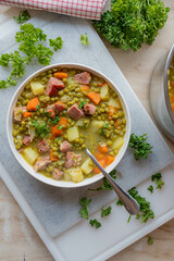 Delicious pea soup with pork meat and vegetables fresh and homemade cooked on a plate