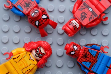Naklejka premium Tambov, Russian Federation - February 03, 2025 Four Lego Marvel character minifigures - Spider-Ham, Daredevil, Firestar and Spider-Man, on a gray baseplate background.