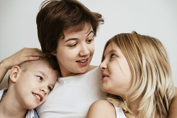 A loving mother with her son and daughter enjoys the magical atmosphere of Christmas and New Year....