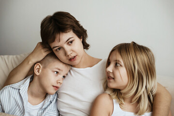 A loving mother with her son and daughter enjoys the magical atmosphere of Christmas and New Year. The family shares joyful moments, playing together, laughing, and creating warm holiday memories