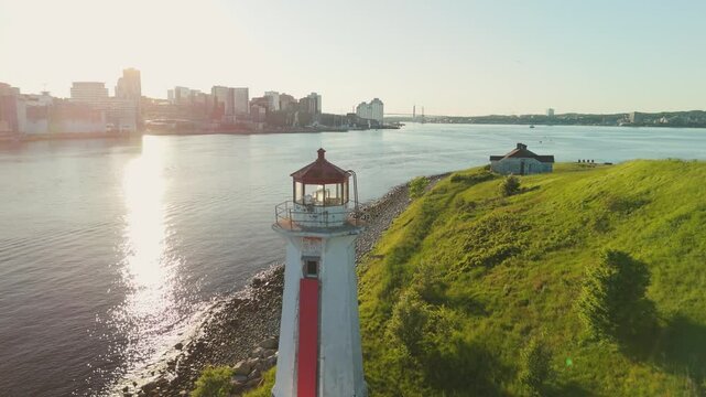 A Beautiful Aerial View Of An Ancient Lighthouse Standing On A Small Island In Halifax Harbor, Nova Scotia. The Sunset Paints The Sky With Vibrant Colors, Adding Magic To This Scenic Landmark.