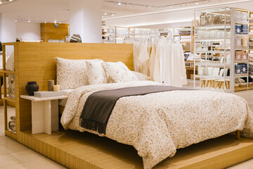 Cozy bedroom display in modern home decor store with bedding and accessories