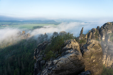 An early morning in mountain. Schrammsteine - group of rocks are a long, strung-out, very jagged in...