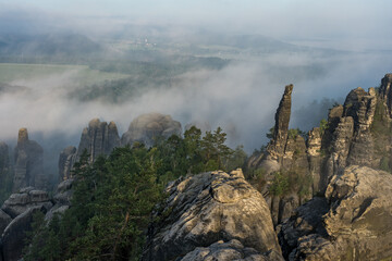 An early morning in mountain. Schrammsteine - group of rocks are a long, strung-out, very jagged in...