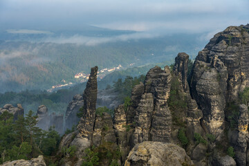 An early morning in mountain. Schrammsteine - group of rocks are a long, strung-out, very jagged in...