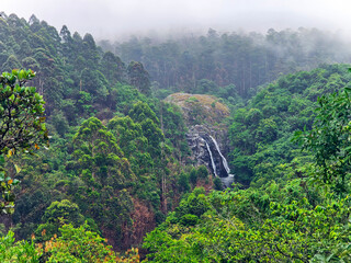 View from above of the misty mountains and Mantenga Waterfalls in Elulwini valley, Swaziland, Southern Africa