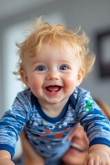 Naklejka premium Baby's Infectious Laughter: A closeup of a baby boy's face erupts in contagious laughter, his bright blue eyes sparkling with joy, a testament to the pure innocence and happiness of childhood. 