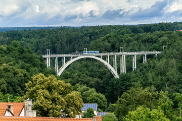 Railway and road arched bridge over a deep valley between two hills in the town of Bechyně. Bridge...