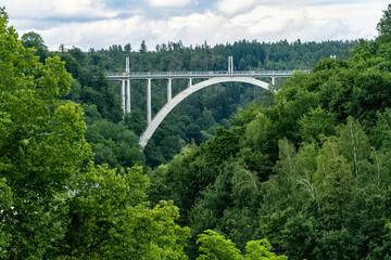 Railway and road arched bridge over a deep valley between two hills in the town of Bechyně. Bridge over the Lužnice River, Czech Republic.