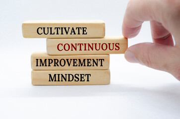Cultivate continuous improvement mindset text on wooden blocks. Continuous Improvement concept