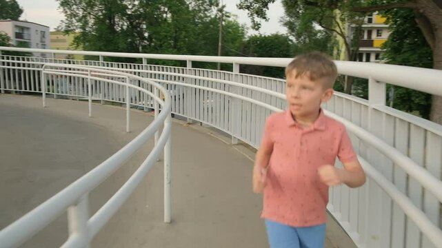A boy runs in the city. Children's sports.