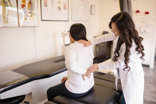 Patient showing doctor back pain