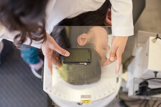 Doctor using equipment to evaluate patient