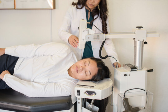 Doctor adjusting patients atlas using equipment