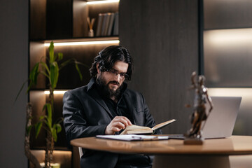 Confident mid aged Caucasian male Lawyer reading books, studying about the case in his office room....