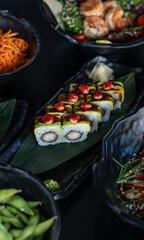 A selection of fresh sushi served on a plate, showcasing an assortment of rolls with vibrant colors...