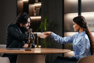 
Happy mid aged Caucasian male Lawyer handshaking greeting client in office. Lawyer Protecting Client Innocents with Supporting Argument. Legal law, advice and justice concept.