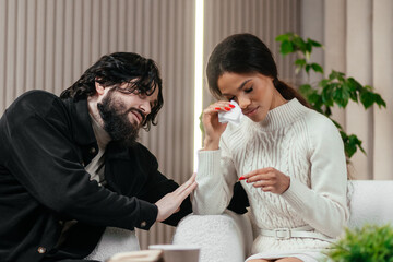Depression, empathy and support with multiracial couple on a sofa in the living room. Mental...