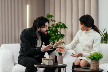 Angry husband and african american wife, biracial couple fighting discussing family problems during session with therapist in office. Relationship and psychology concept