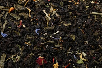 Pile of dry tea leaves as background, top view