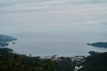 Evening view of the popular tourist town of Budva on the Adriatic coast in Montenegro, the Balkan Peninsula. The island hotel Sveti Stefan is visible in the distance
