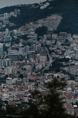 Evening view of popular tourist town of Budva on the Adriatic coast in Montenegro, the Balkan Peninsula. View from a distance, from the pass. Modern buildings and cars are driving through the streets