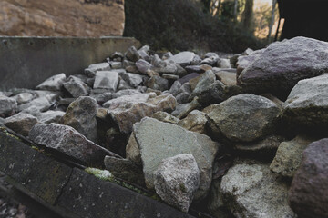 Pile of gravel stones on a construction site in early morning light