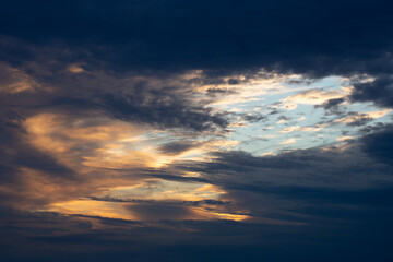 Fototapeta premium Beautiful dark colorful dramatic sky with clouds at sunset or sunrise.