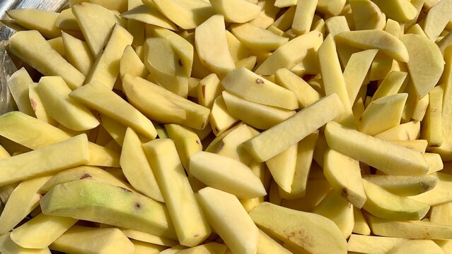 Freshly cut Bitto pieces neatly arranged on a plate, showcasing their texture and vibrant color, ready to be enjoyed in a delicious meal.