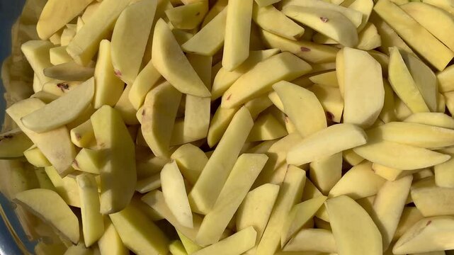 Freshly cut Bitto pieces neatly arranged on a plate, showcasing their texture and vibrant color, ready to be enjoyed in a delicious meal.