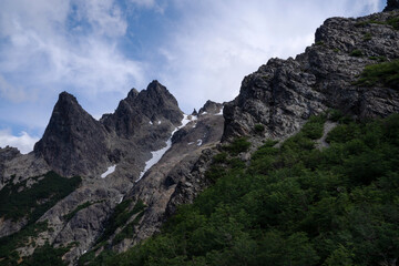 Obraz premium View of Cerro Lopez rocky mountain and Patagonian forest in Bariloche, under a beautiful summer sky with clouds