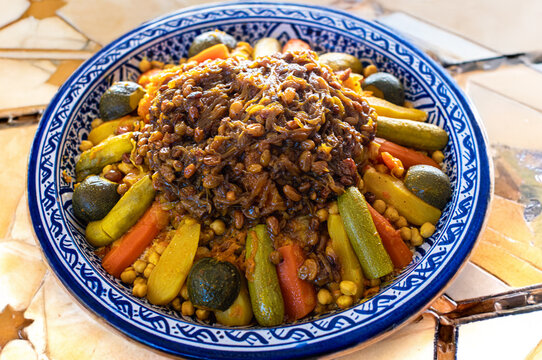 Appetizing Moroccan couscous dish decorated with fresh vegetables close-up
