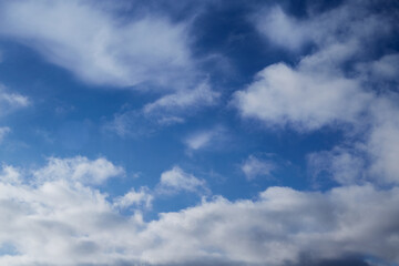 White feathery clouds in the blue sky
