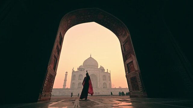 A woman in an Indian sari dancing in slow motion at the Taj Mahal, India