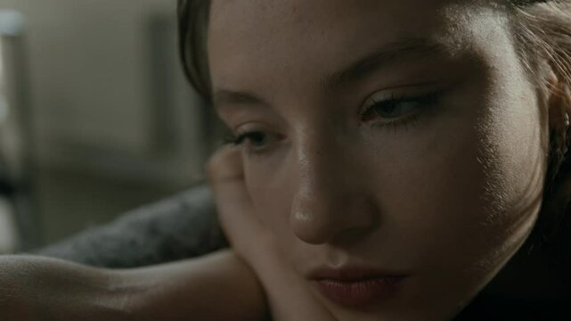 Close-up shot of depressed Caucasian girl with restless eyes having disturbing thoughts and experiencing insomnia