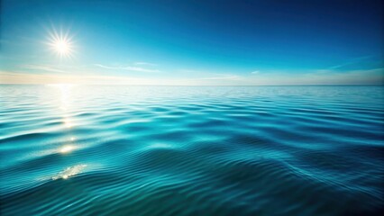 Obraz premium Serene Ocean Surface with Bright Sun Shining on Calm Water