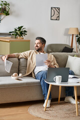 Obraz premium Relaxing in a modern living room while reviewing documents with a smile