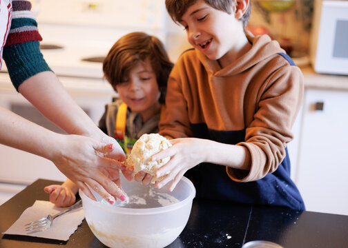 Children having fun and helping prepare food in the kitchen