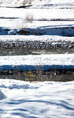Partview of a landscape of a river covered by white snow