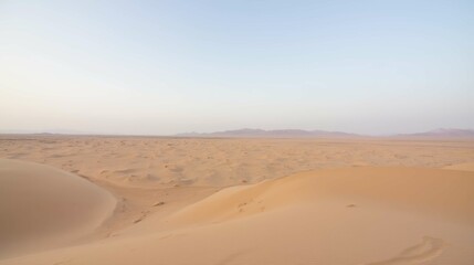 Fototapeta na wymiar Serene Desert Landscape with Sand Dunes and Clear Blue Sky