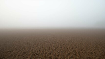 Serene Foggy Landscape with Sand and Soft Gray Background