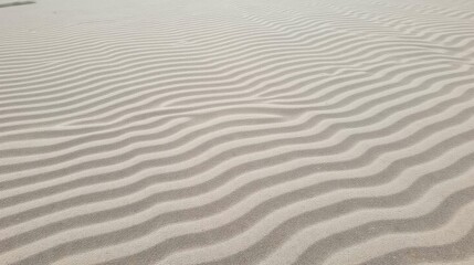 Obraz premium Textured Patterns of Light and Shadow on Smooth Sand Surface