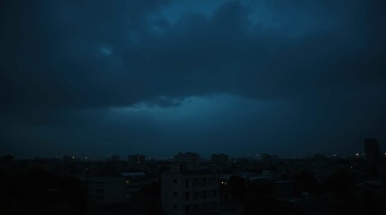 Fototapeta premium Dark Storm Clouds Over Cityscape at Dusk with Lights Glimmering